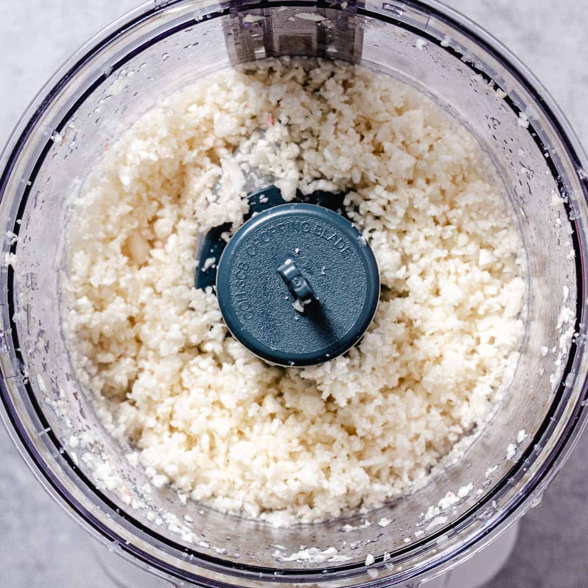 Fresh cauliflower florets pulsed in a food processor to make homemade cauliflower rice.