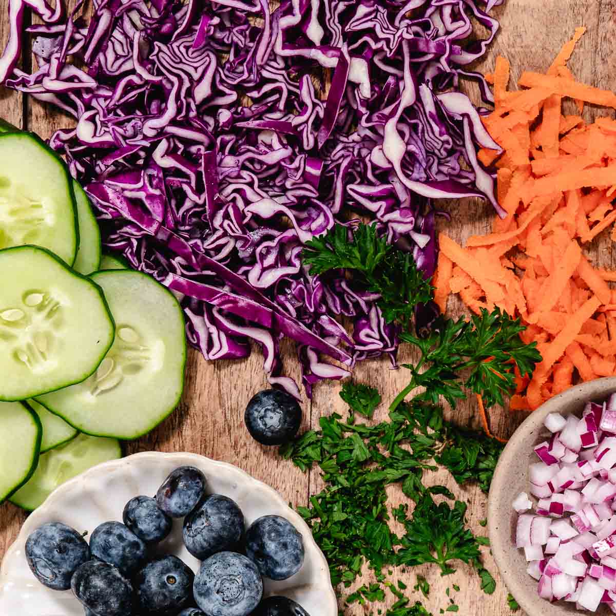 chopped veggies for veggie burger bowl: cabbage, cauliflower rice, carrots. onions, and parsley