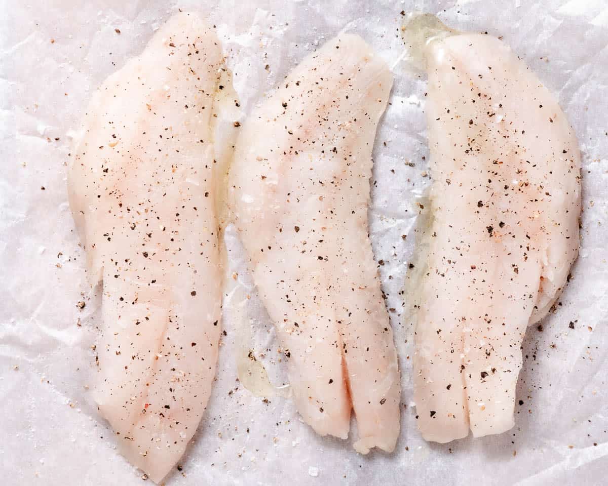 Blackbelly rosefish fillets seasoned with salt and pepper before cooking.