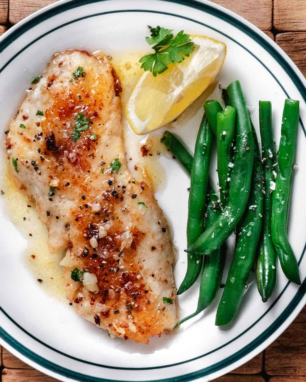 Pan-fried blackbelly rosefish with garlic butter, lemon, and green beans