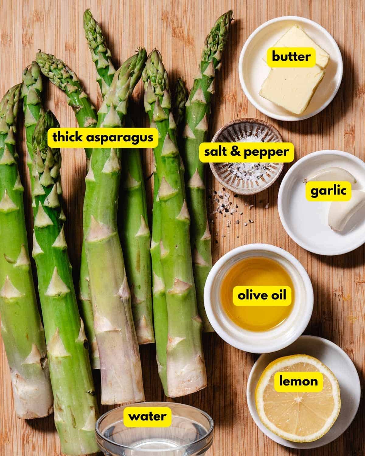 Ingredients for thick asparagus with lemon butter: asparagus, butter, garlic, olive oil, water, lemon, salt, and pepper.