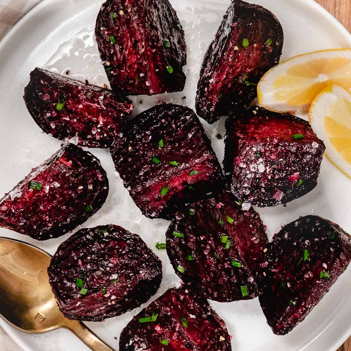 Roasted red beets with a lemon wedge.