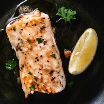 Fresh grilled mahi mahi fillet garnished with herbs and served with a lemon wedge, perfect for seafood lovers and healthy eating.