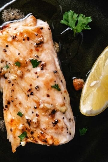 Fresh grilled mahi mahi fillet garnished with herbs and served with a lemon wedge, perfect for seafood lovers and healthy eating.
