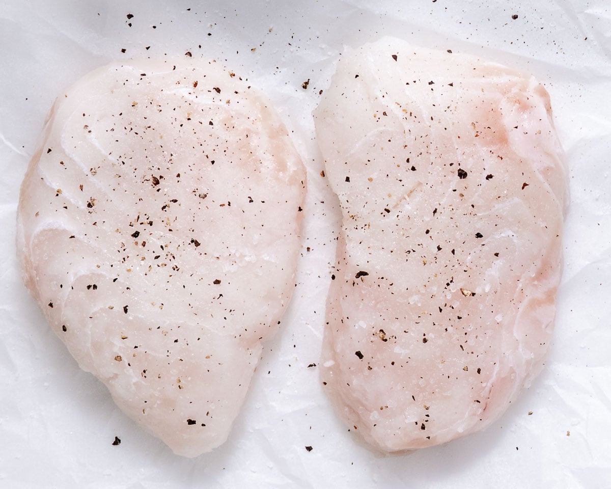 Halibut fillets seasoned with salt and pepper.