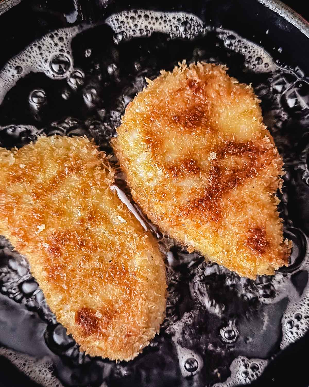 Frying halibut in a skillet at home.