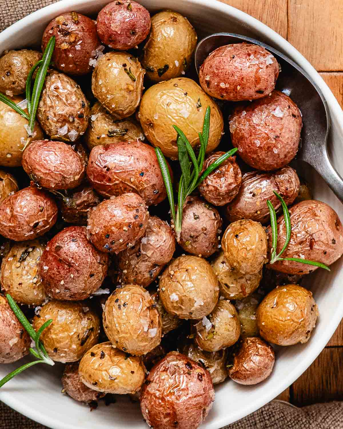 Roasted small potatoes with olive oil, rosemary, cracked black pepper, sea salt, and fresh rosemary.