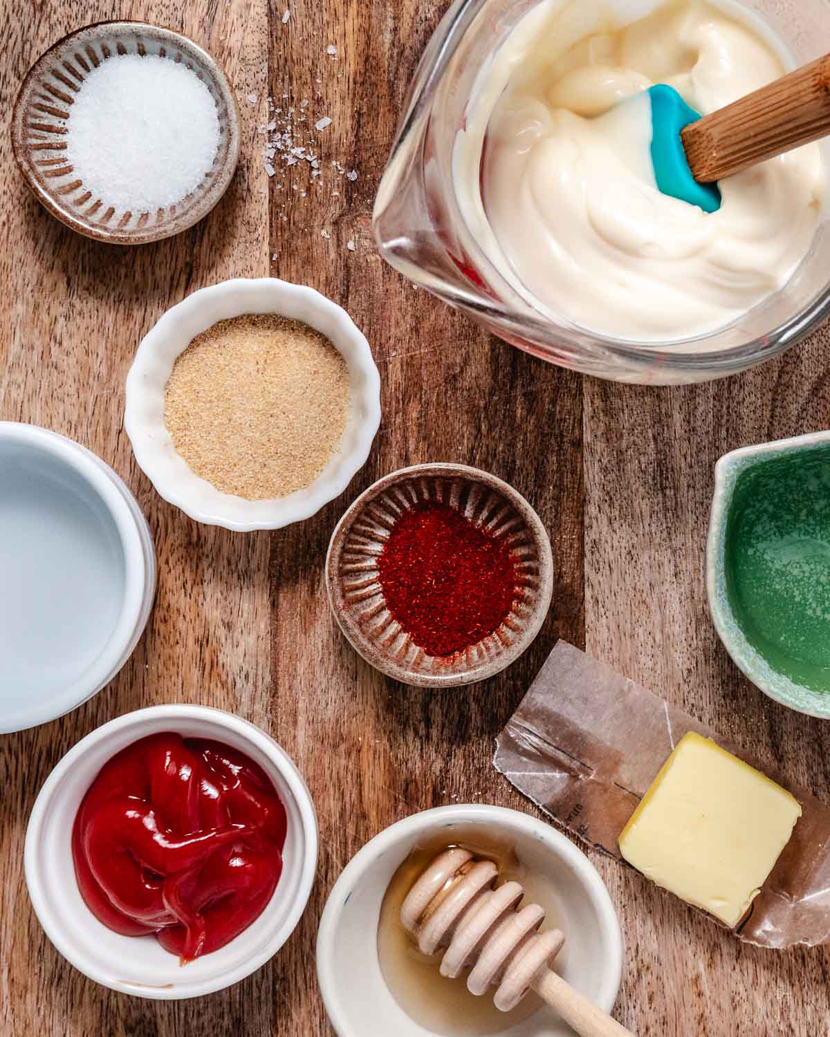 Ingredients for homemade Yum Yum Sauce, including mayonnaise, ketchup, honey, paprika, garlic powder, and seasonings.