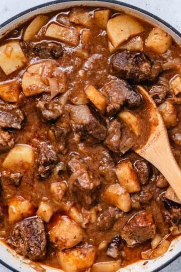 Finished Hungarian beef goulash with tender chuck roast, potatoes, and onions in a Dutch oven.