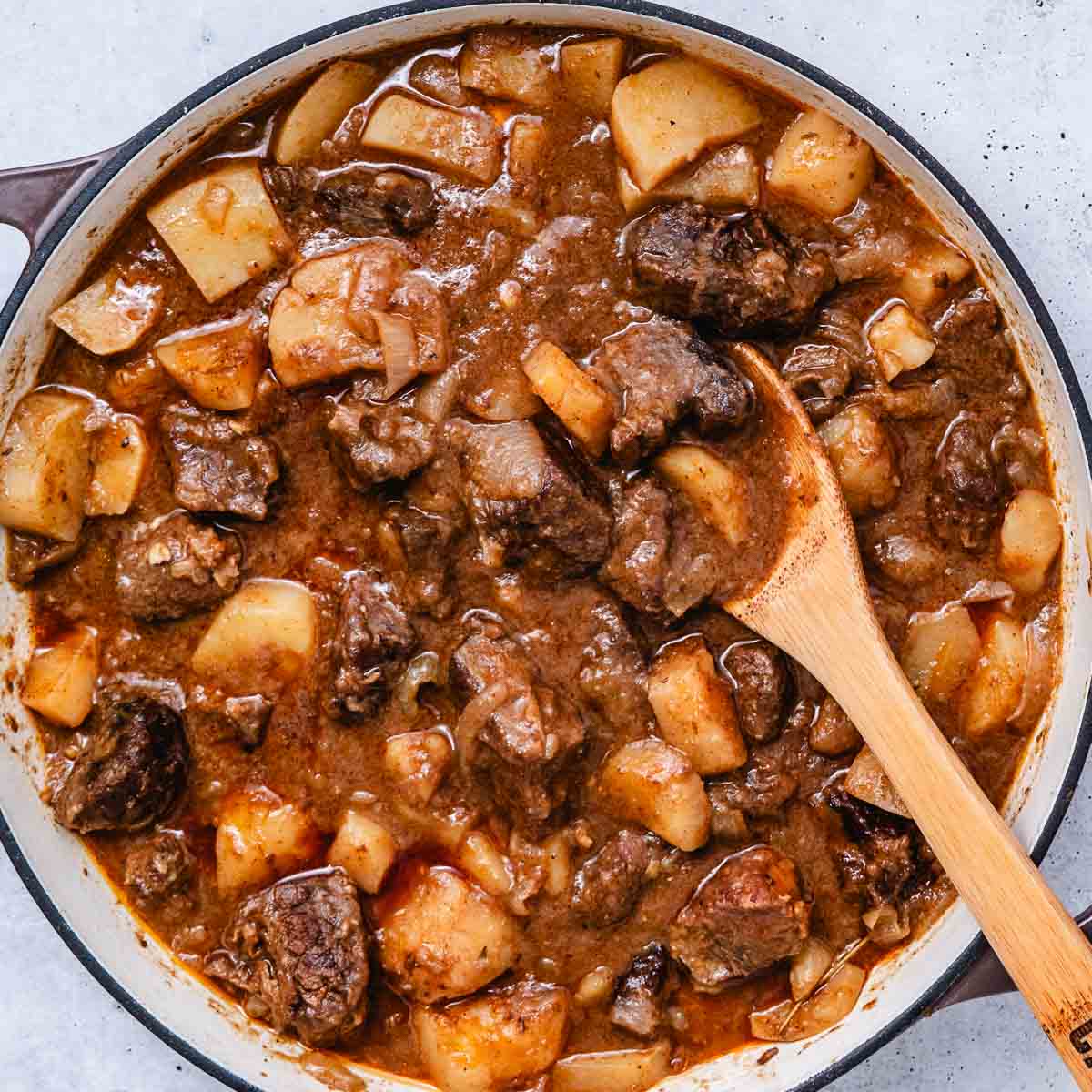 Finished Hungarian beef goulash with tender chuck roast, potatoes, and onions in a Dutch oven.