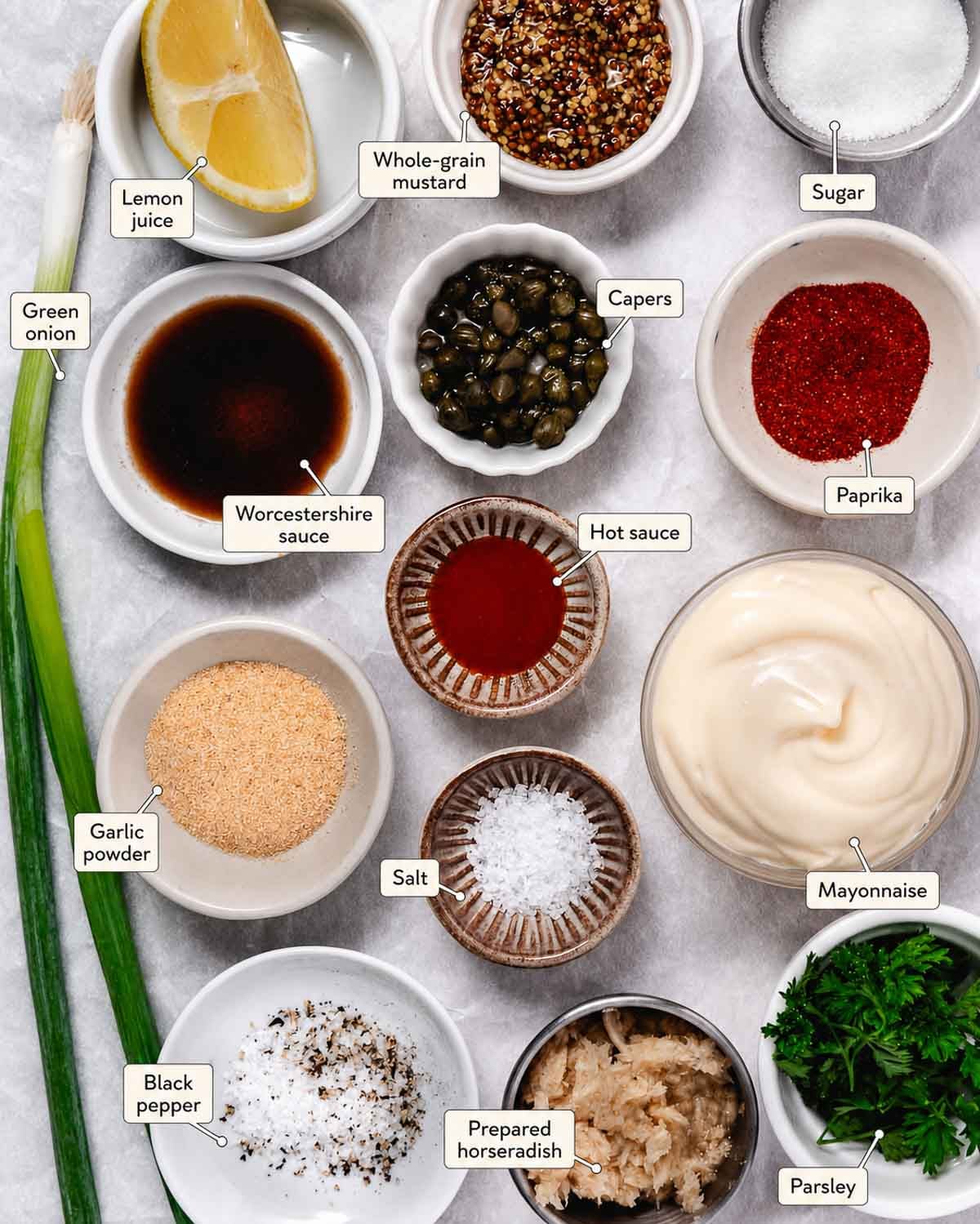 Ingredients for remoulade sauce, including mayonnaise, mustard, lemon, capers, horseradish, herbs, and seasonings.