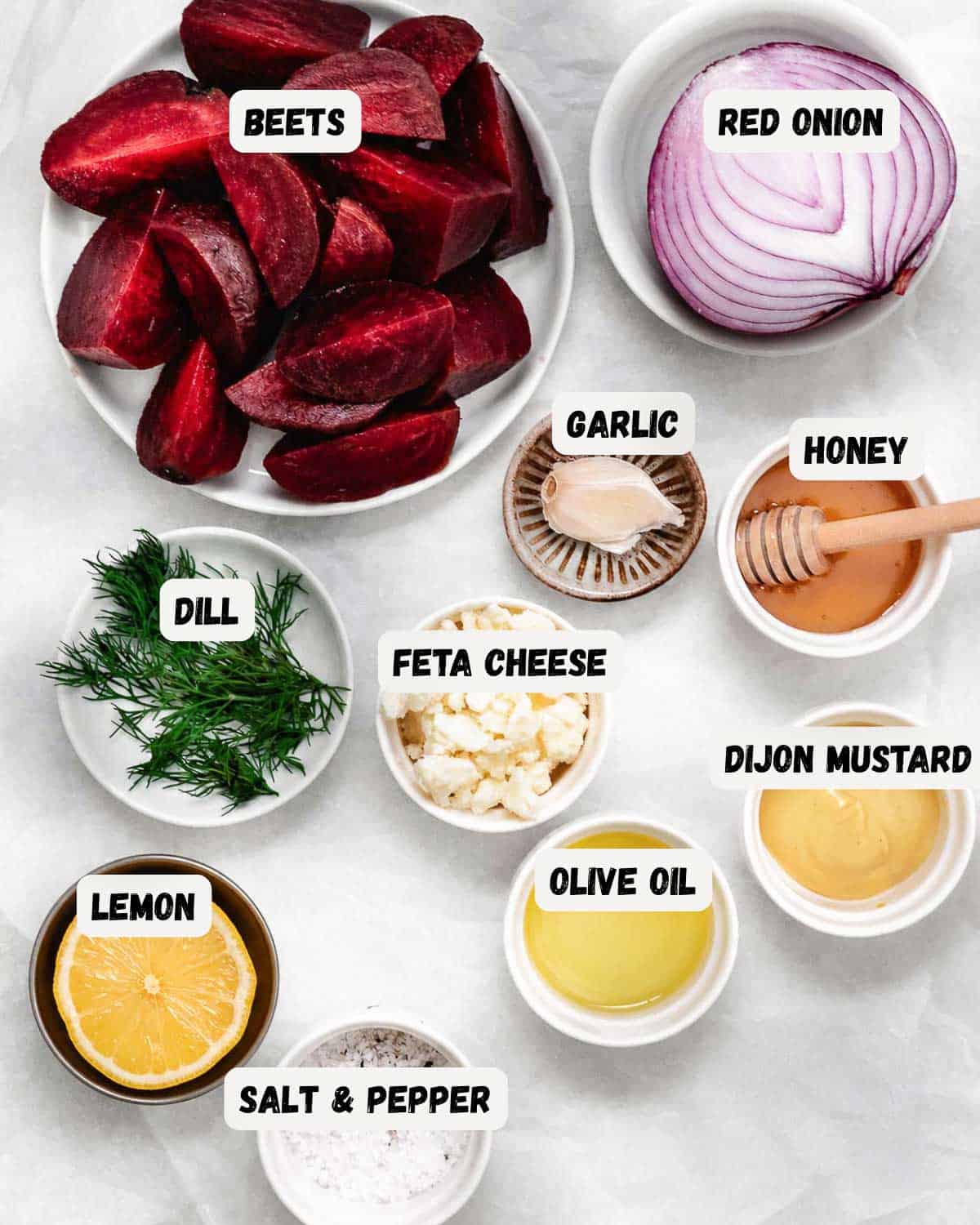 Beet salad ingredients: cooked beets, red onion, feta cheese, fresh dill, lemon, olive oil, Dijon mustard, honey, garlic, and salt.