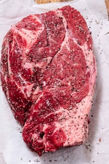 Boneless chuck roast seasoned with salt and pepper.