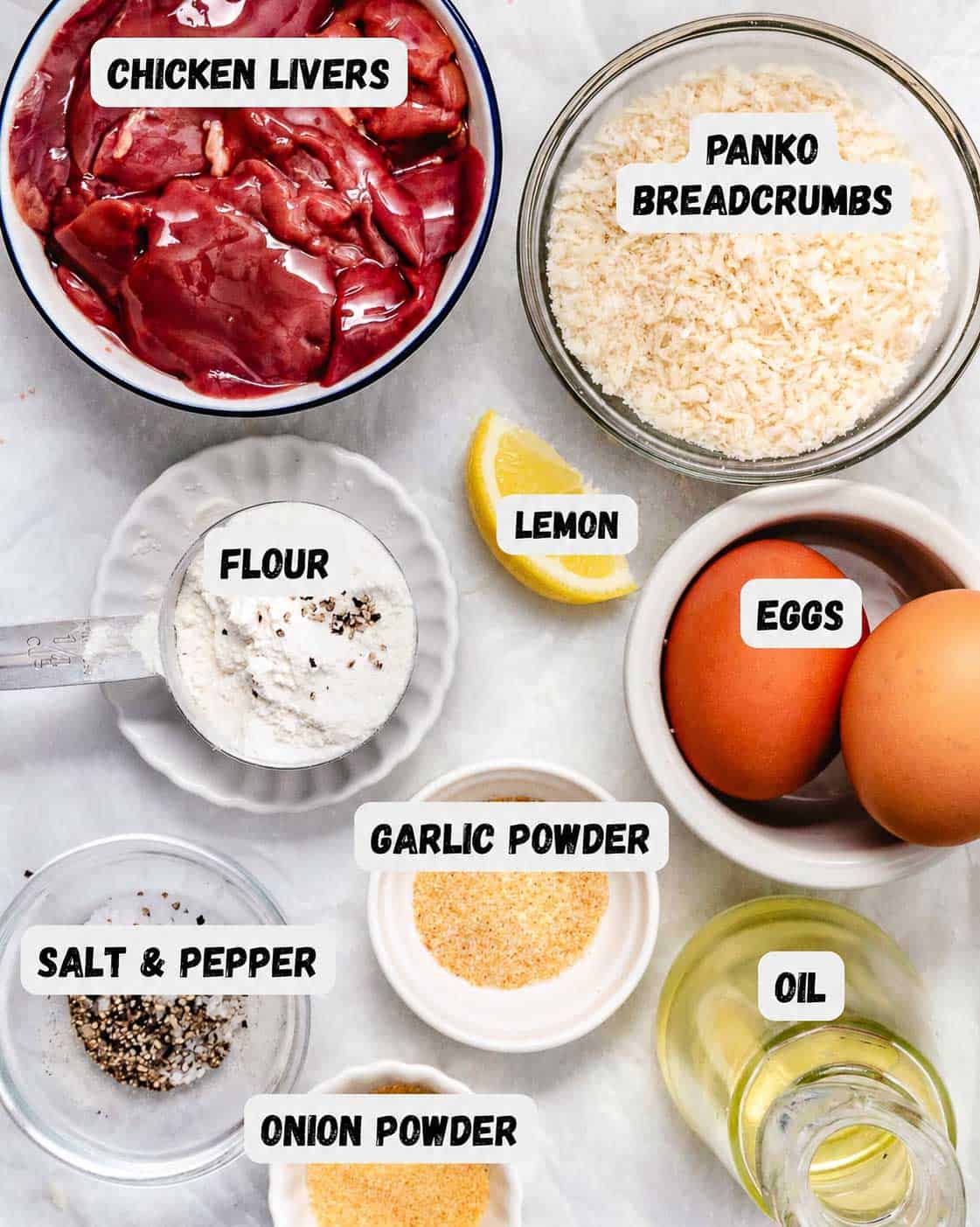 Ingredients for fried chicken livers: chicken livers, panko breadcrumbs, flour, eggs, garlic powder, onion powder, salt, pepper, and oil, arranged in labeled bowls.